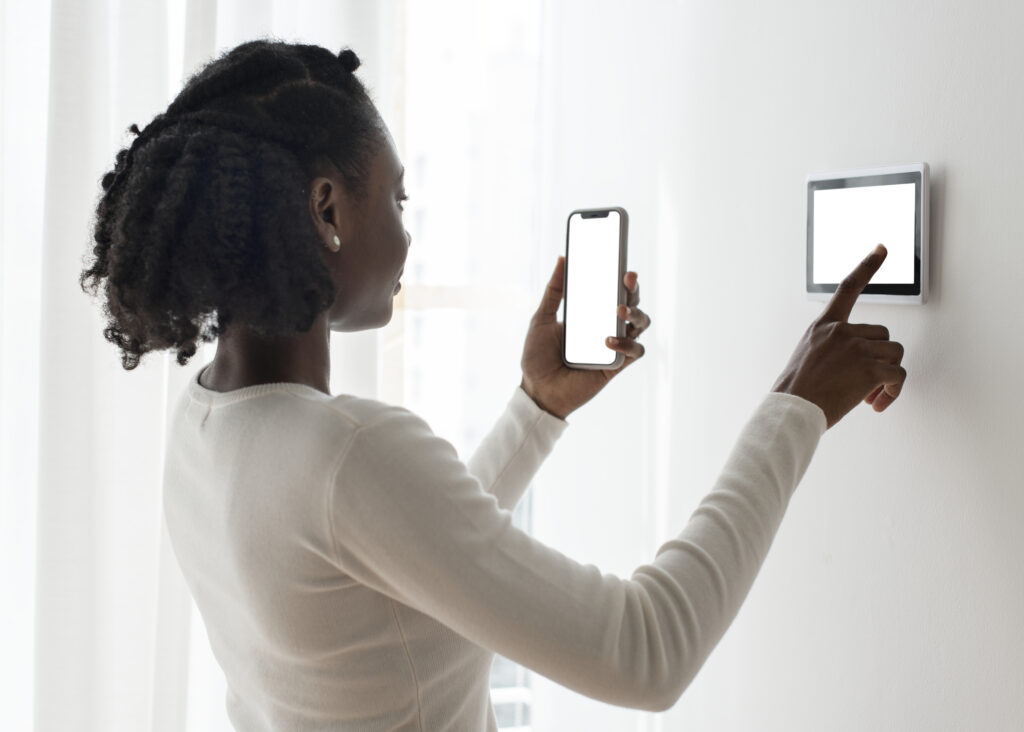 woman pressing on smart home automation panel monitor